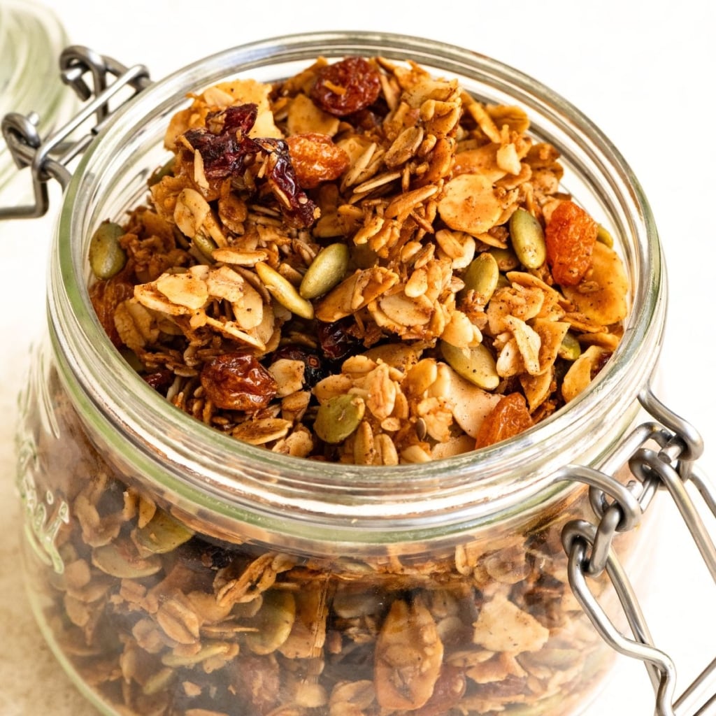 Glass canister filled with baked granola.