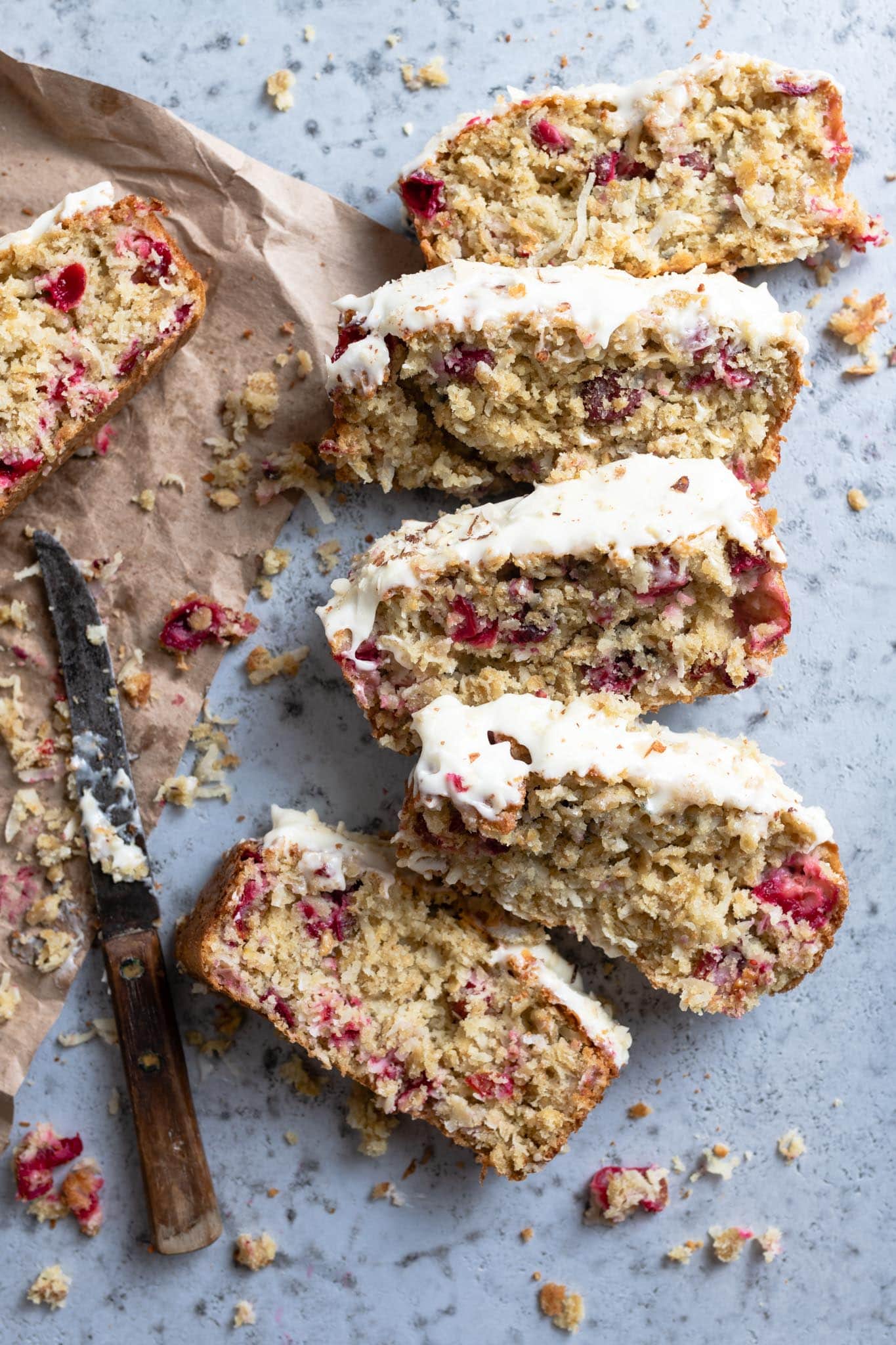 sliced coconut cranberry bread with cream cheese frosting