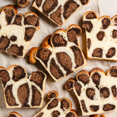 Overhead of slices of bread with chocolate leopard spots.