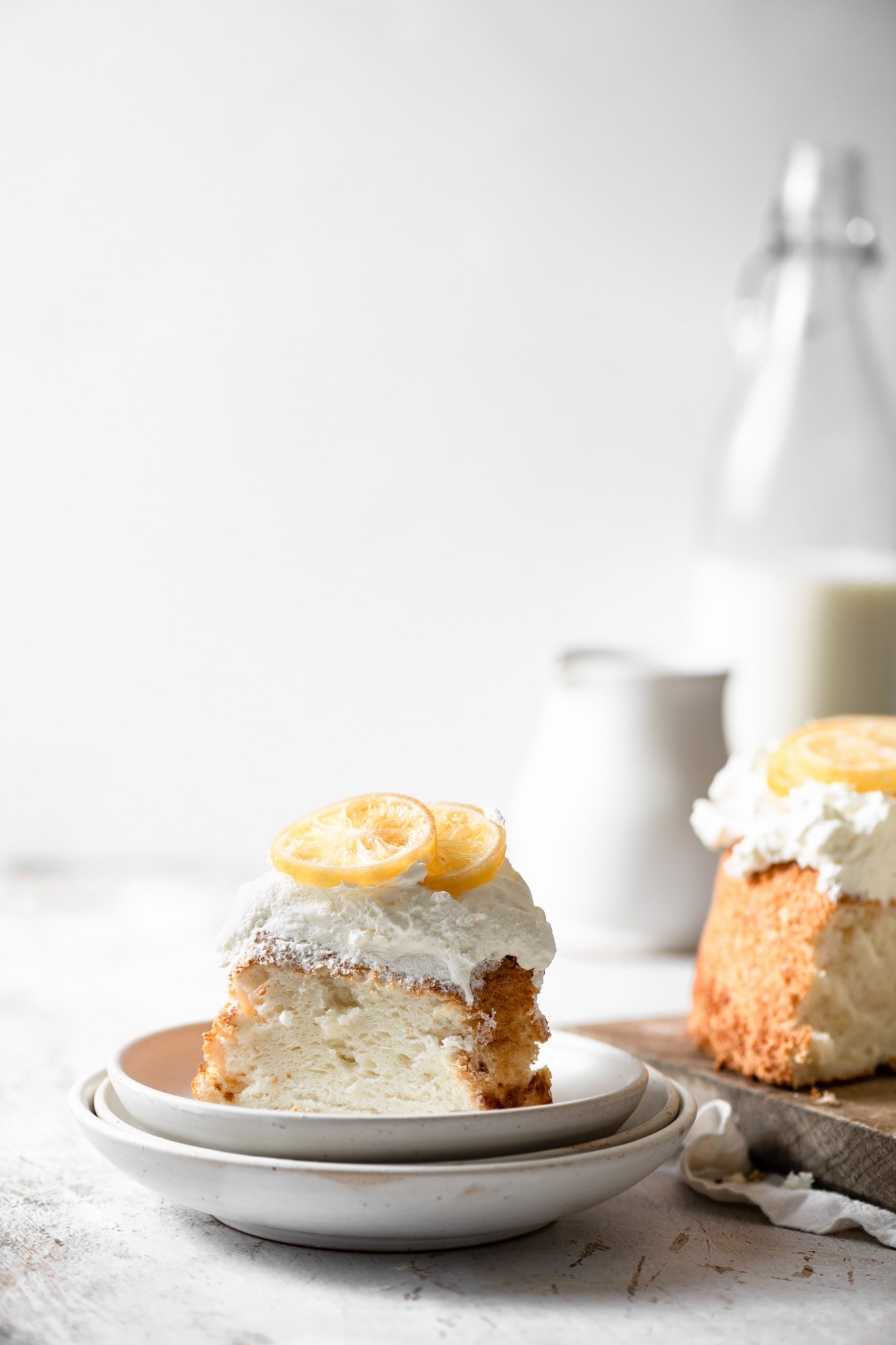 Angel Food Cake with candied lemons and glass of milk.