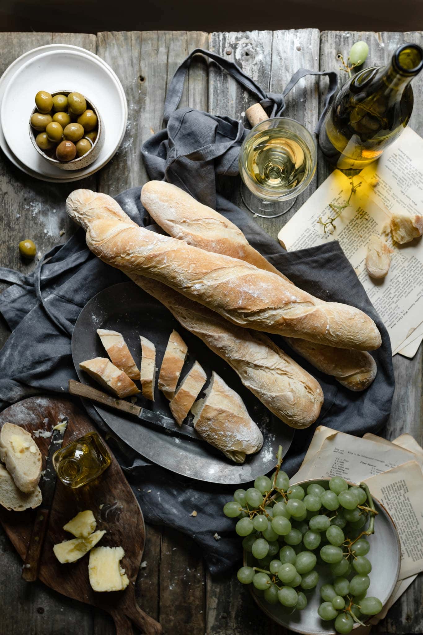 Homemade french baguettes with olives and olive oil.