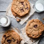 Chocolate Chunk Cookies stacked with a glass of milk.