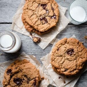 Chocolate Chunk Cookies stacked with a glass of milk.