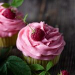 Lemon cupcakes topped with raspberry buttercream.