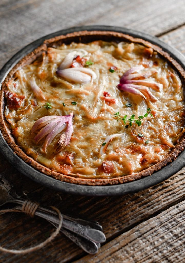 Close up of an onion tart in pie plate.