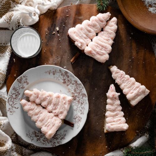 Christmas tree shaped blondies with peppermint frosting on table.