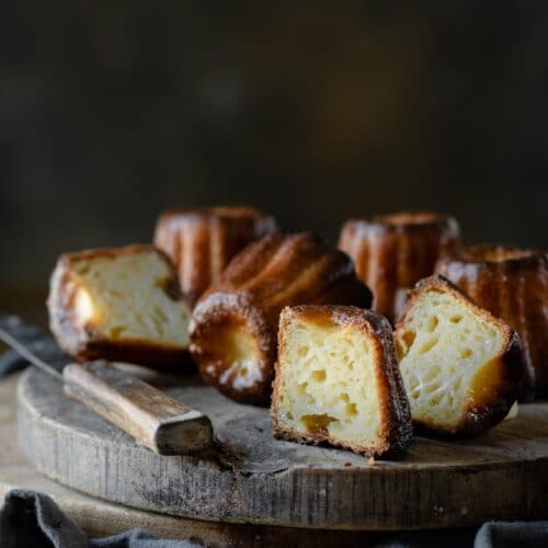 Sliced rum caneles on cutting board.