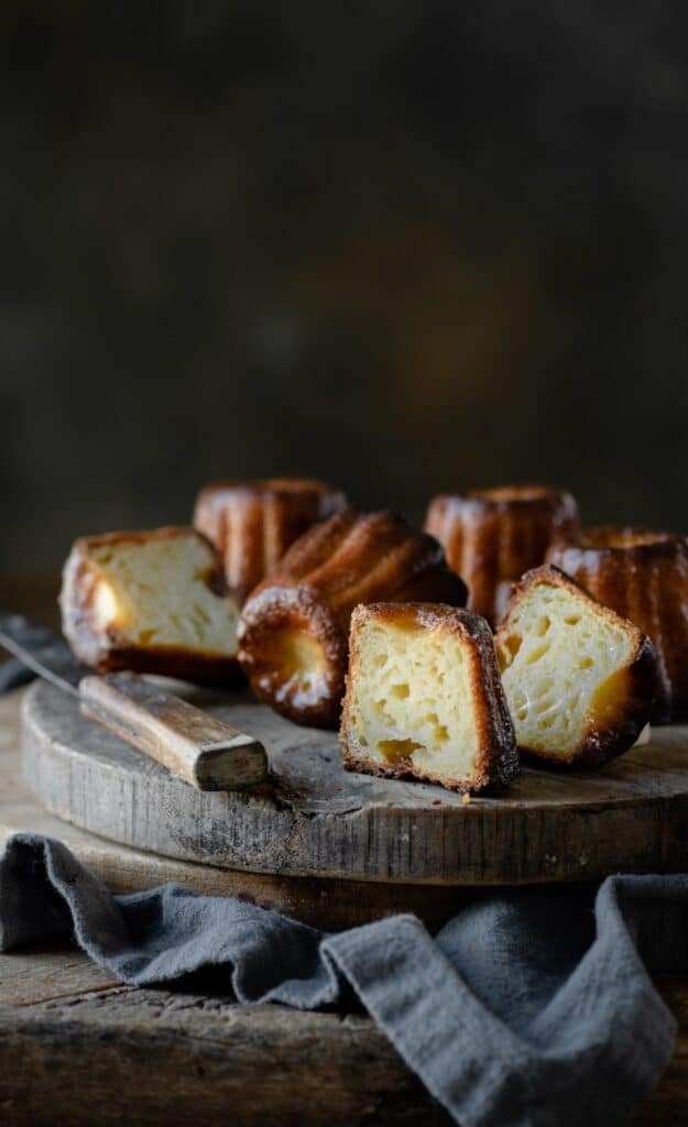 Sliced rum caneles on cutting board.