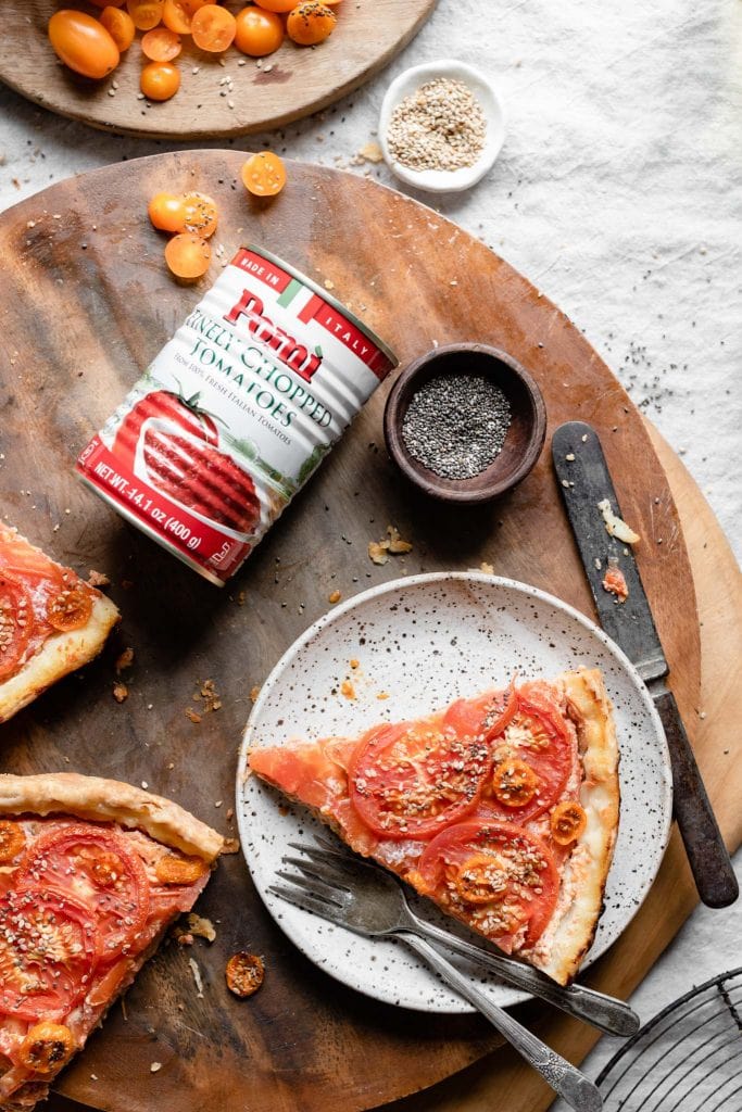 Jar of chopped tomatoes with slices of tomato tart.