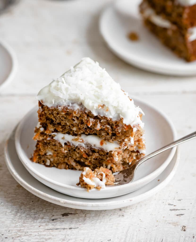 Cloe up of asingle slice of cream cheese frosted carrot cake.