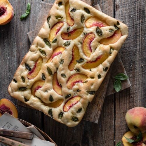 Peach focaccia bread loaf on cutting board.