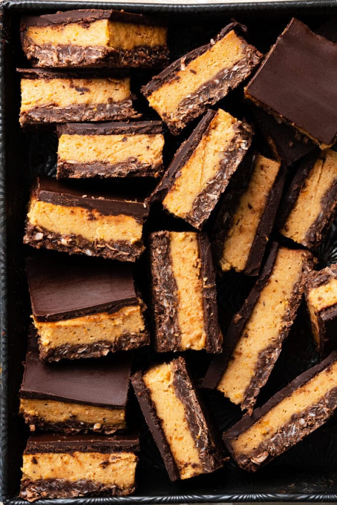 Slices of chocolate pumpkin bars in a metal tin.