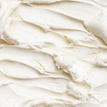 Close up of vanilla Swiss buttercream frosting swirled with lines and dollups.