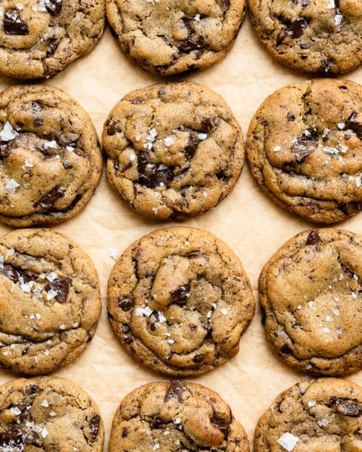 Soft baked chocolate chip cookies on a piece of parchment paper.