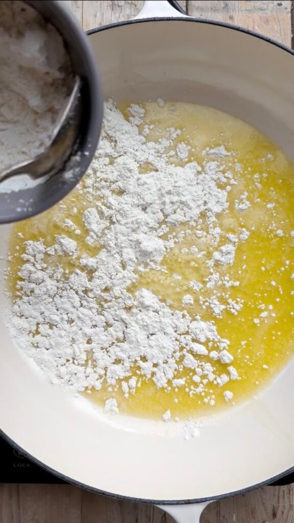 Flour being sprinkled onto melted butter.
