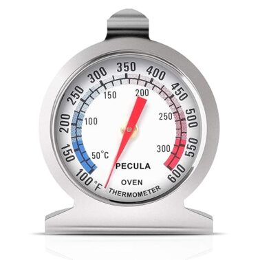 Closeup of a metal oven thermometer.