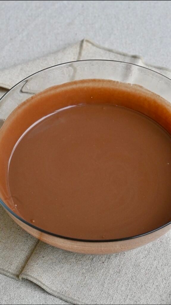 Creamy chocolate batter in a large mixing bowl.