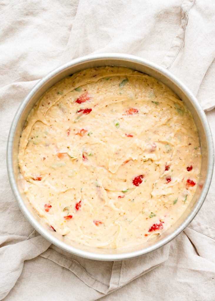 Overhead of strawberry cake batter in a cake pan.