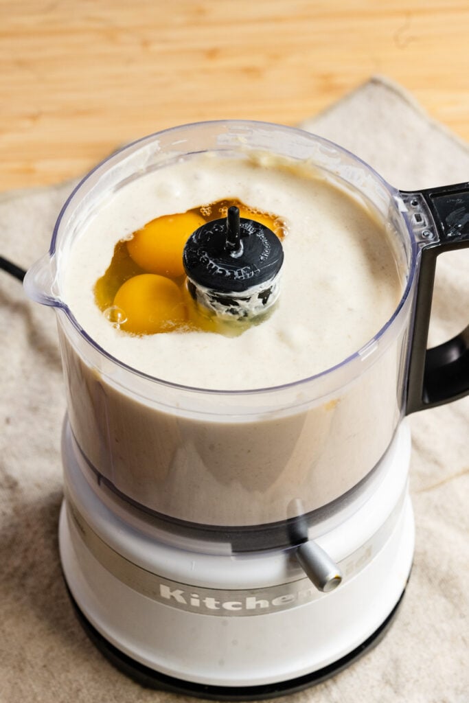 Eggs and banana batter in a mini food processor.