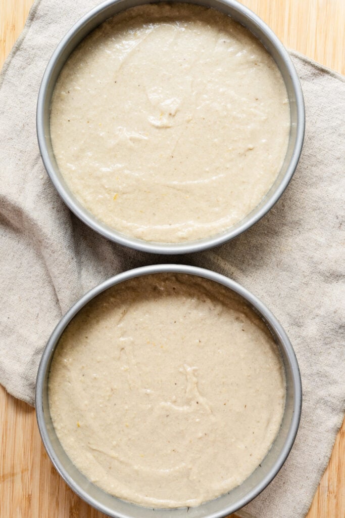 Overhead of two cake pans filled with batter.