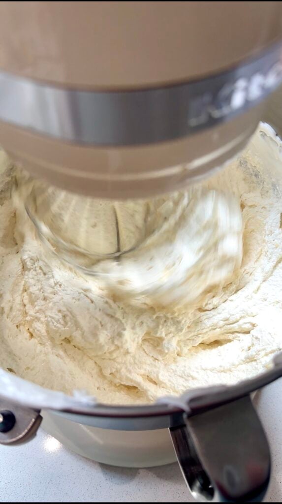 Broken Swiss meringue buttercream in a stand mixer bowl.