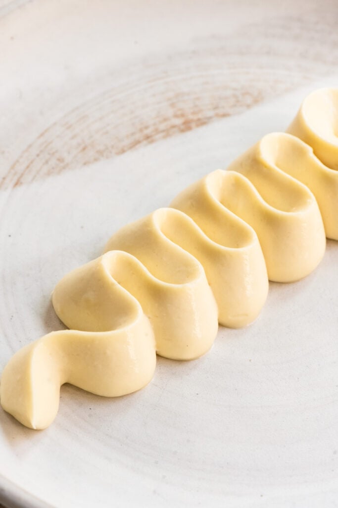 Banana cremeux piped onto a plate.