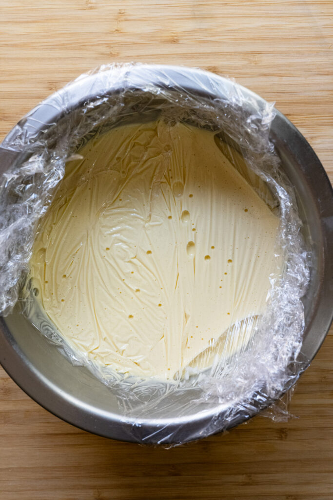 Banana cremeux in a bowl covered with plastic wrap.
