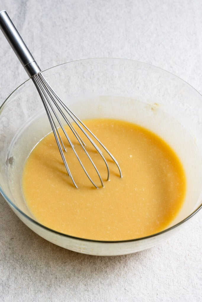 Whisk in a bowl of sugar, creme fraiche, and eggs.