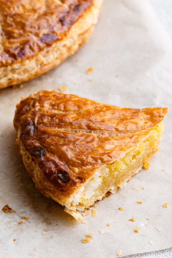 Slice of galette de rois cake filled with French almond cream.