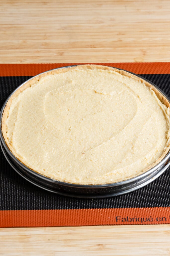 Pare-baked tart shell filled with unbaked almond cream.