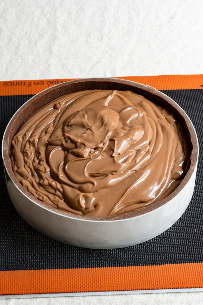 Chocolate pastry cream inside of a chocolate crust lined pastry ring.