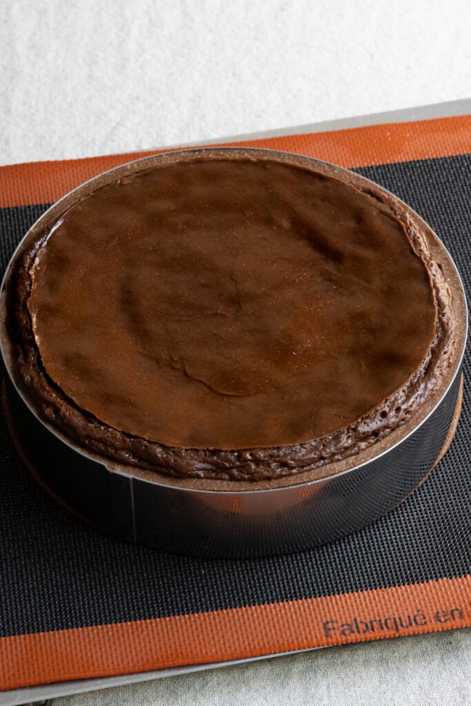 Baked chocolate French flan straight from the oven on a baking tray.
