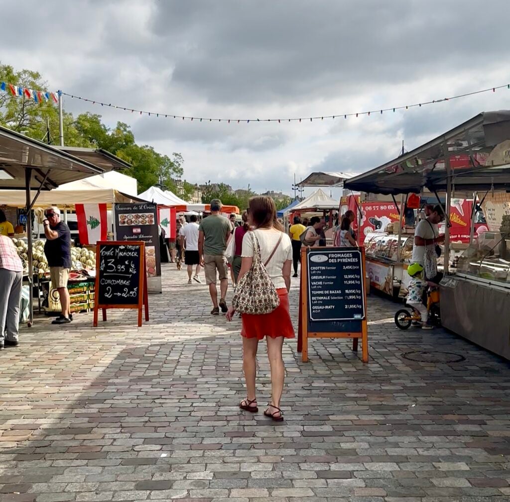 Jenn Davis walking through a French darmer's market.