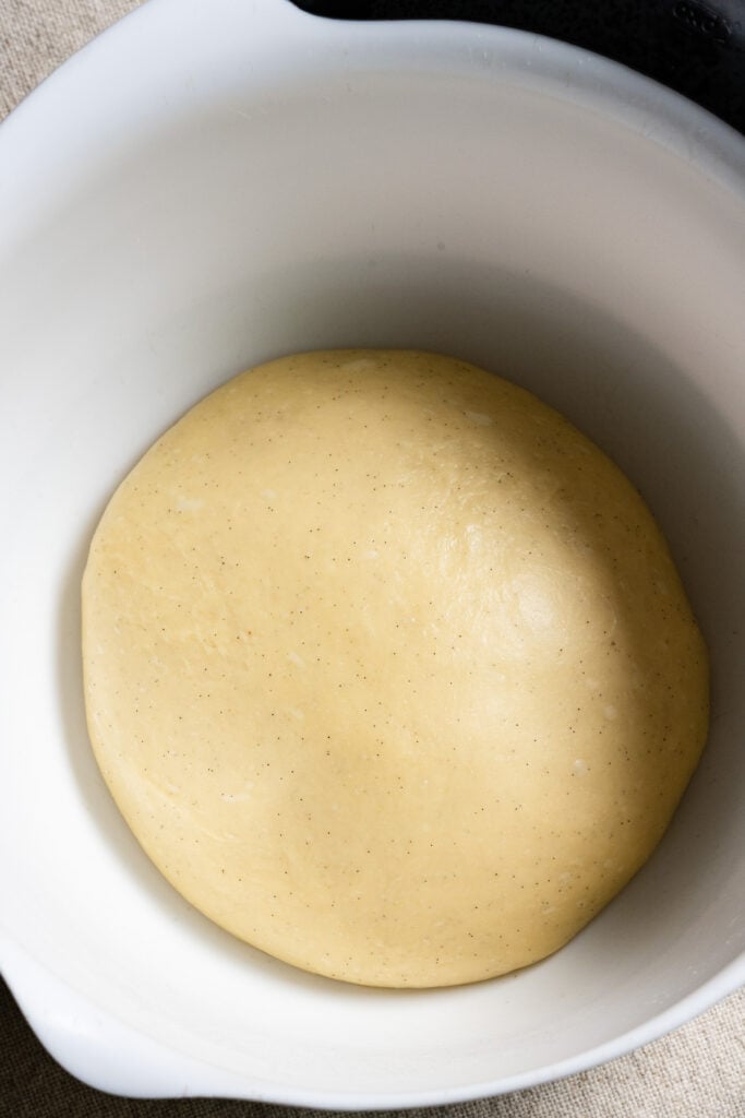 Brioche donut dough in a bowl.
